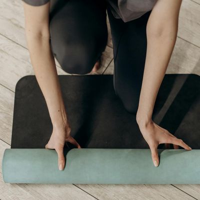 Close-up of a yoga mat on a wooden floor.